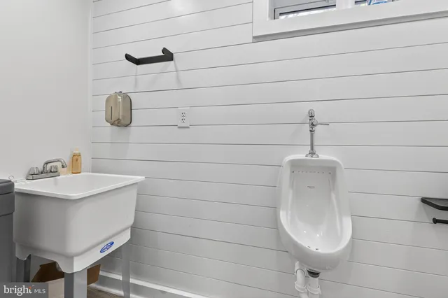 a view of a patio with a dining table and chairs with potted plants