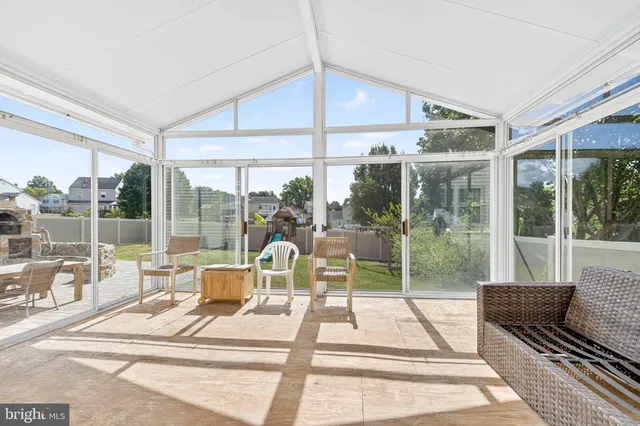 a view of a house with swimming pool and sitting area