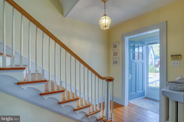 a view of entryway and hall with wooden floor