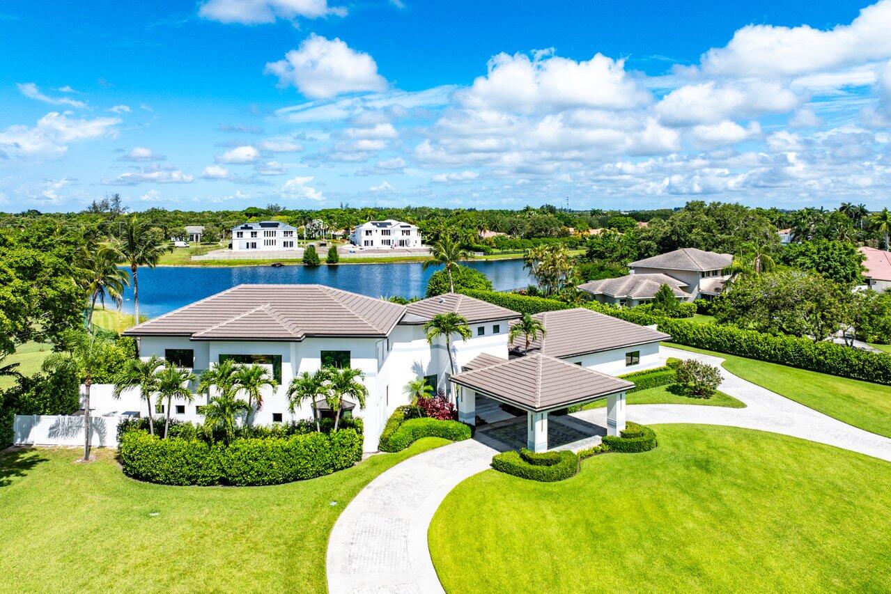a view of a swimming pool with lawn chairs under an umbrella