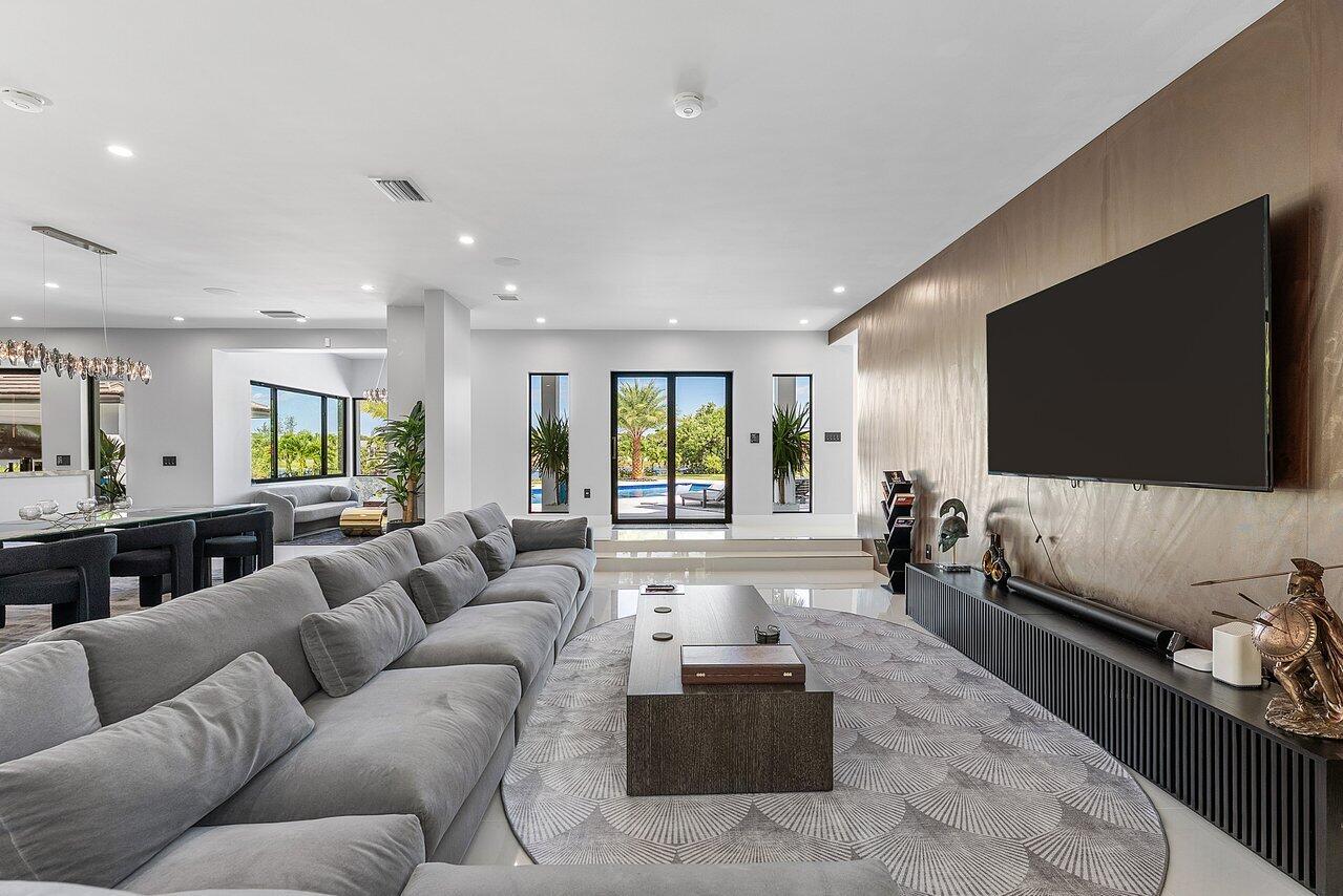 8387 Sawpine Road Delray Beach, FL 33446 - Photo 12 of 57 a living room with furniture and a flat screen tv