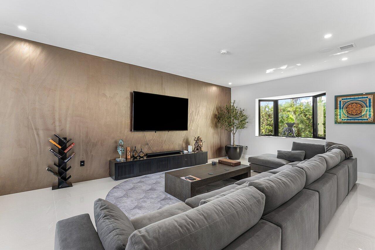 8387 Sawpine Road Delray Beach, FL 33446 - Photo 13 of 57 a living room with furniture and a flat screen tv