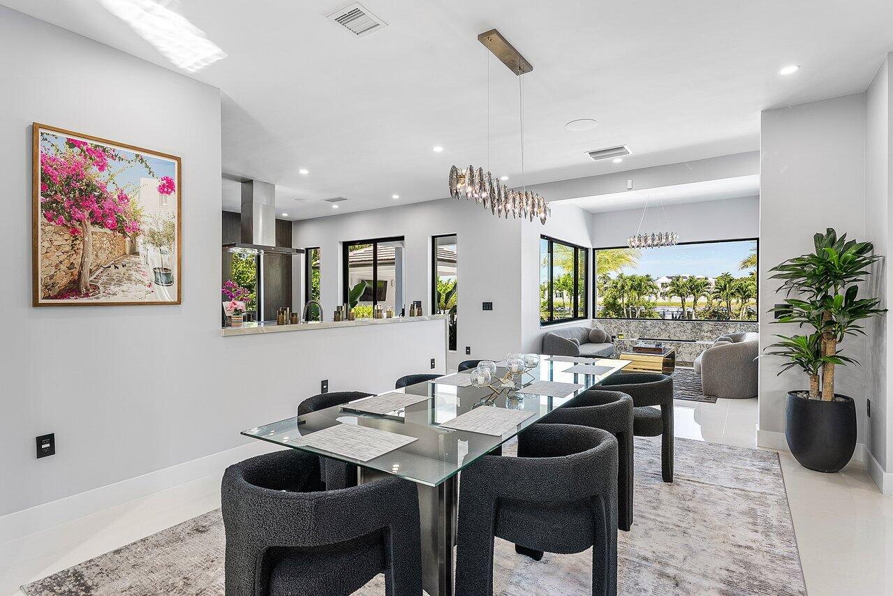8387 Sawpine Road Delray Beach, FL 33446 - Photo 14 of 57 a view of a dining room with furniture window and wooden floor