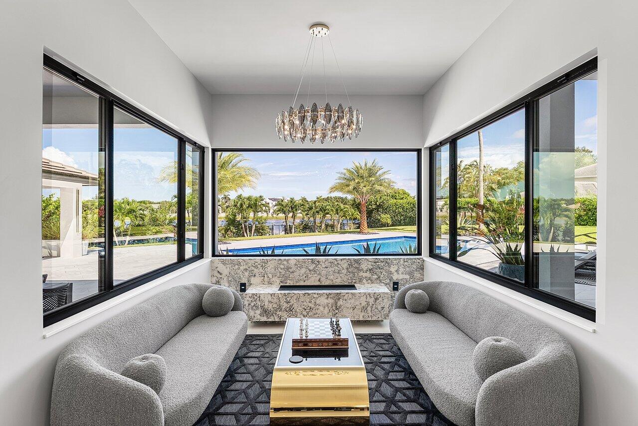 8387 Sawpine Road Delray Beach, FL 33446 - Photo 15 of 57 a living room with furniture and a large window