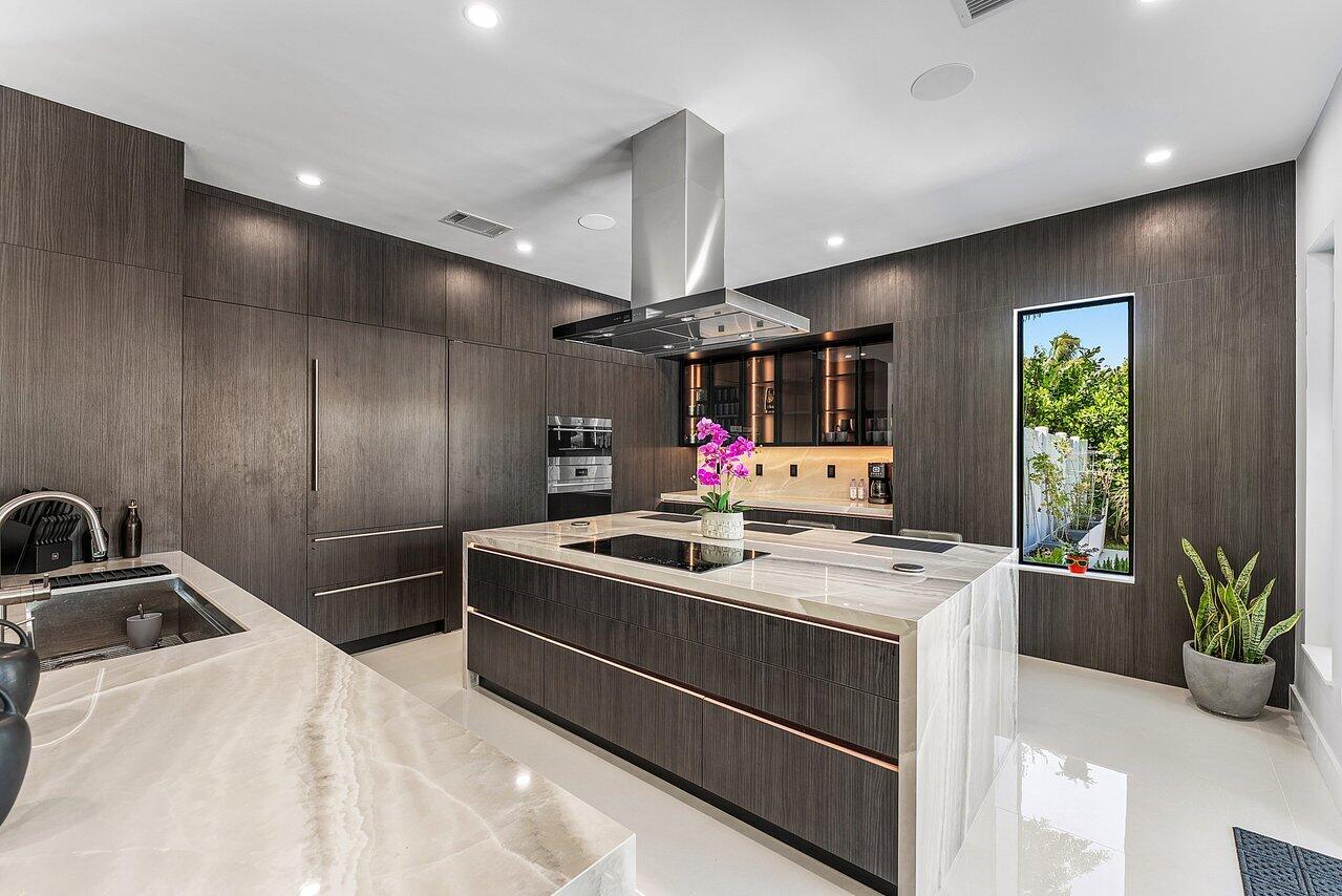 8387 Sawpine Road Delray Beach, FL 33446 - Photo 16 of 57 a kitchen with a stove and a refrigerator