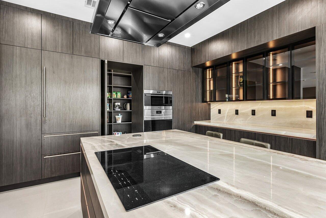 8387 Sawpine Road Delray Beach, FL 33446 - Photo 17 of 57 a kitchen with stainless steel appliances granite countertop a sink and cabinets