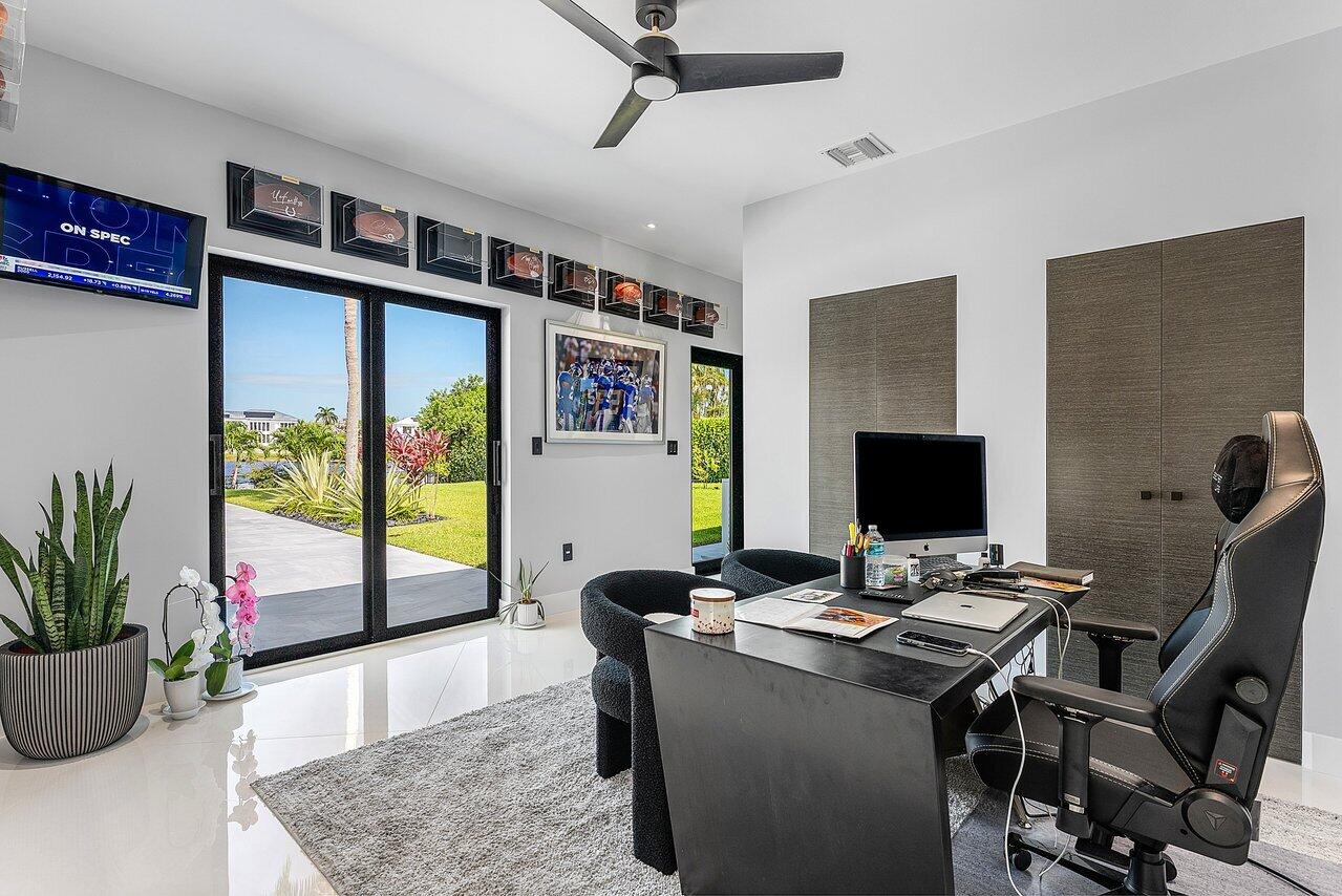 8387 Sawpine Road Delray Beach, FL 33446 - Photo 20 of 57 a workspace with furniture and potted plant