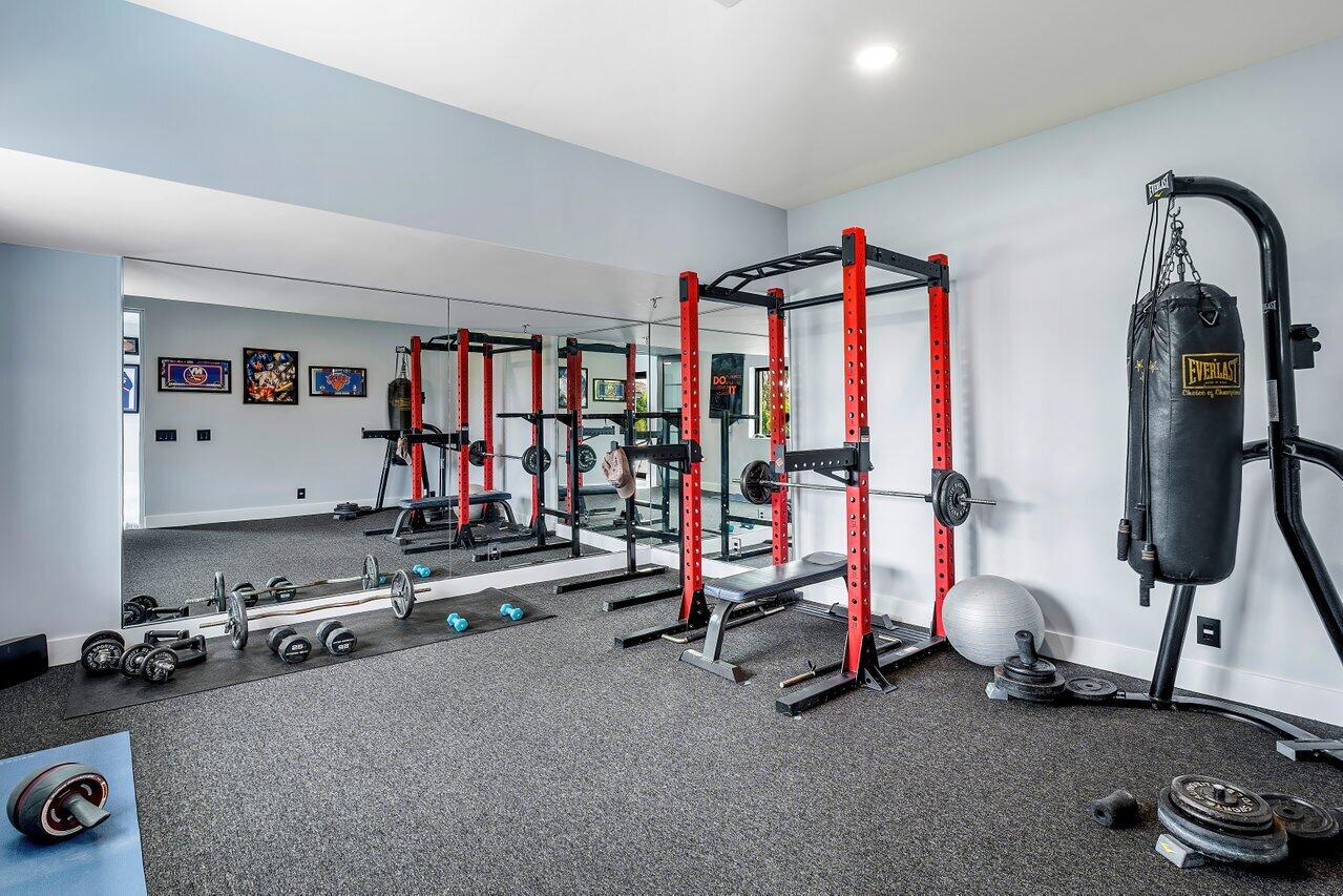8387 Sawpine Road Delray Beach, FL 33446 - Photo 22 of 57 a room with gym equipment and mirror