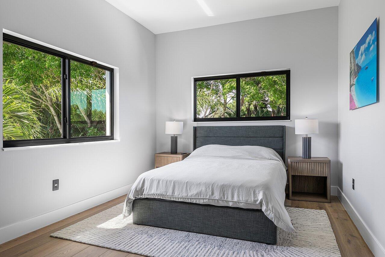 8387 Sawpine Road Delray Beach, FL 33446 - Photo 26 of 57 a bedroom with a large bed and a window