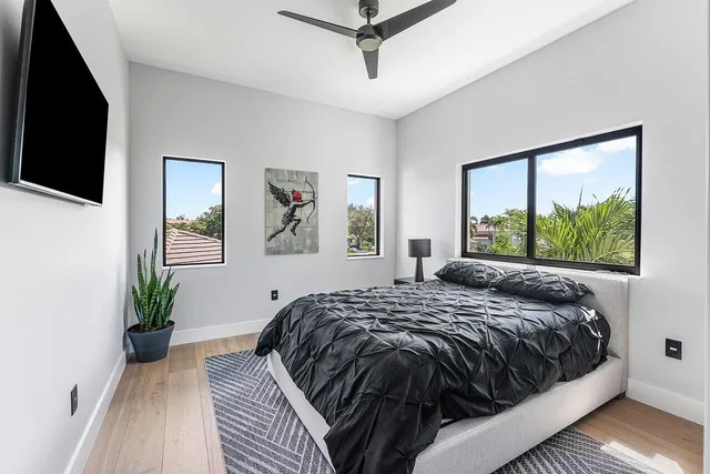 a large white kitchen with a large window