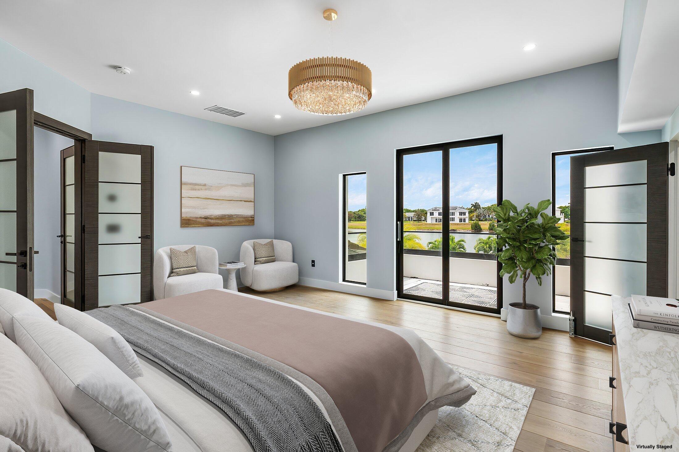 8387 Sawpine Road Delray Beach, FL 33446 - Photo 30 of 57 a bedroom with a large bed and a chandelier