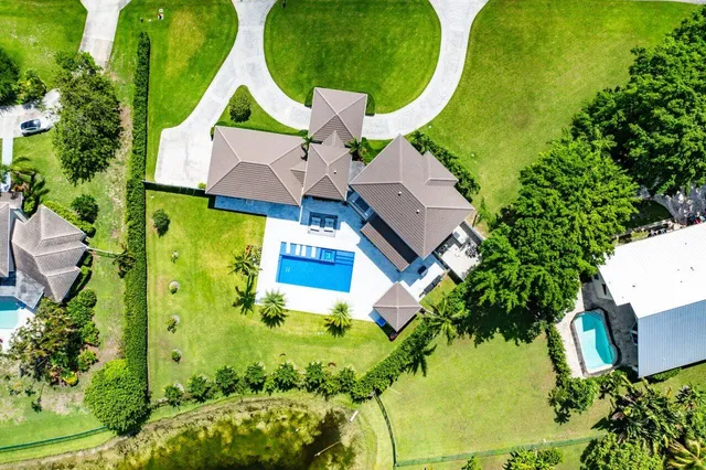 an aerial view of residential house with swimming pool