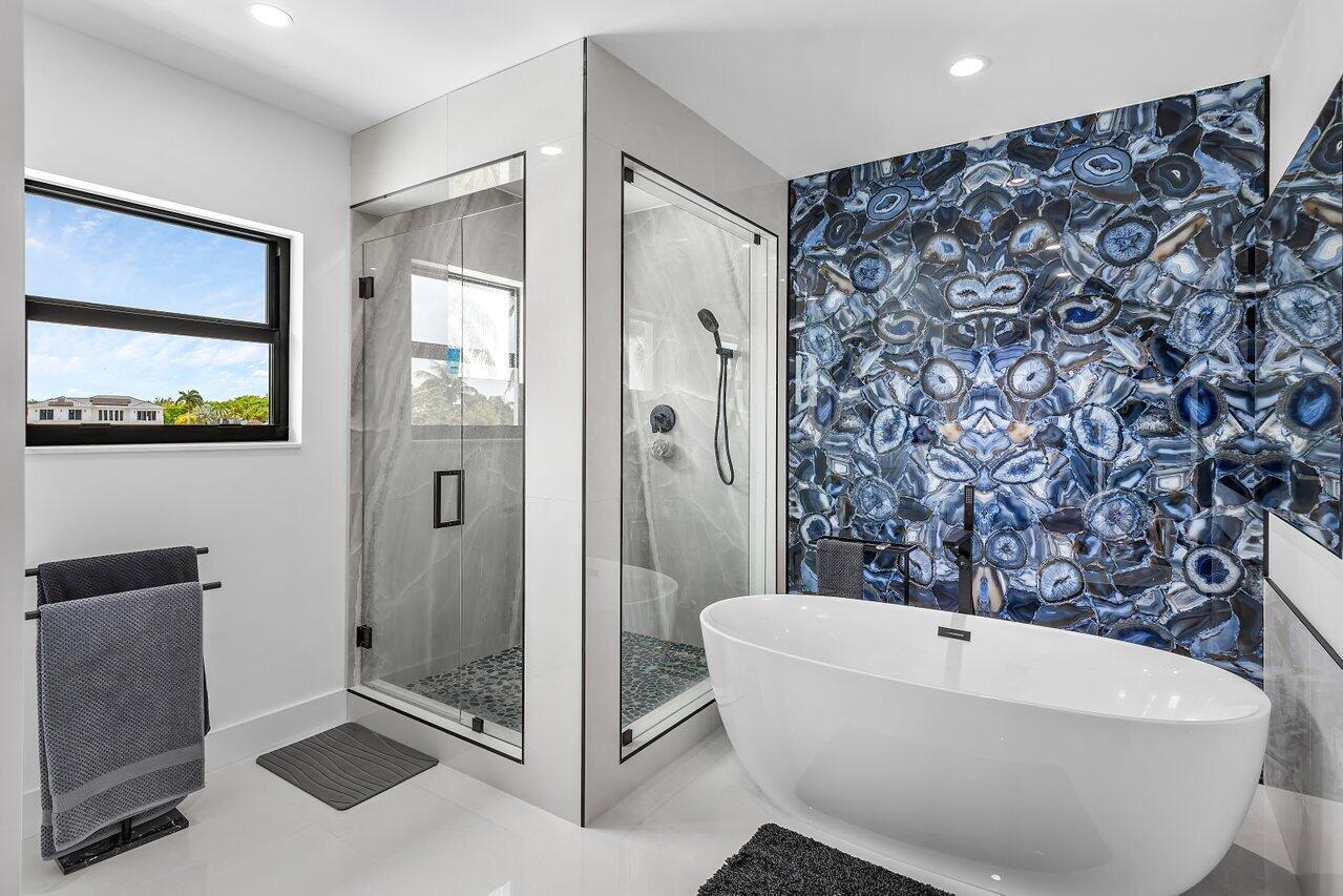 8387 Sawpine Road Delray Beach, FL 33446 - Photo 34 of 57 a bathroom with a bathtub and shower