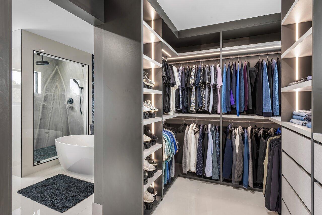 8387 Sawpine Road Delray Beach, FL 33446 - Photo 36 of 57 a view of walk in closet with clothes and shoes