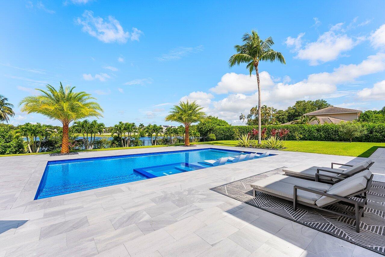 8387 Sawpine Road Delray Beach, FL 33446 - Photo 38 of 57 a view of swimming pool with lounge chair and palm trees