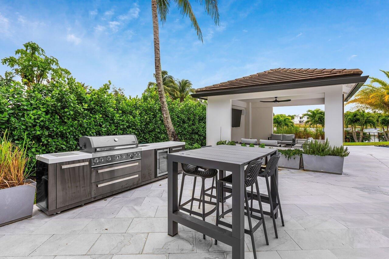 8387 Sawpine Road Delray Beach, FL 33446 - Photo 40 of 57 a patio with table and chairs