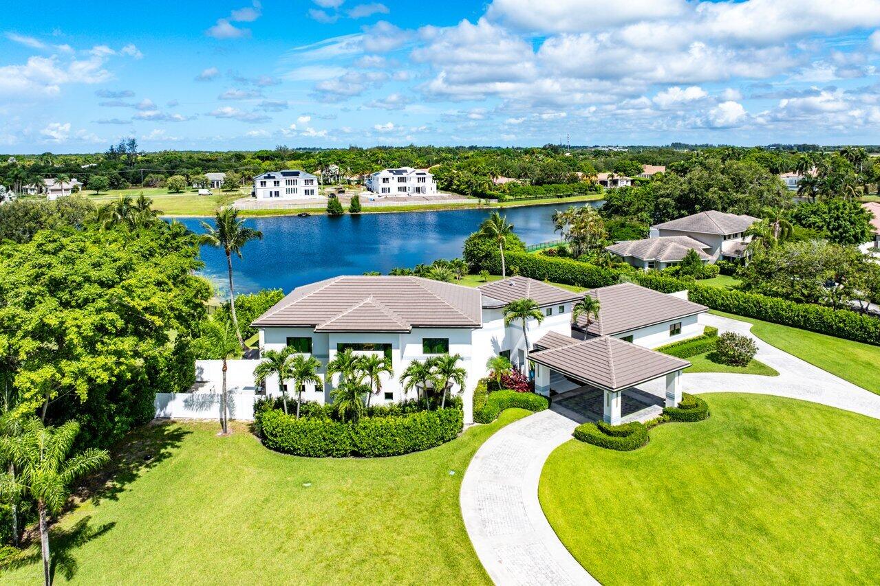 8387 Sawpine Road Delray Beach, FL 33446 - Photo 4 of 57 an aerial view of a house with swimming pool and mountain view