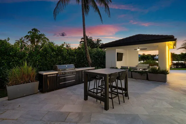 a swimming pool with outdoor seating and yard