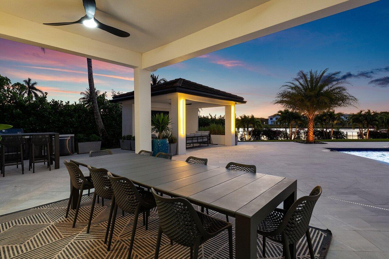8387 Sawpine Road Delray Beach, FL 33446 - Photo 46 of 57 a outdoor dining space with furniture and city view
