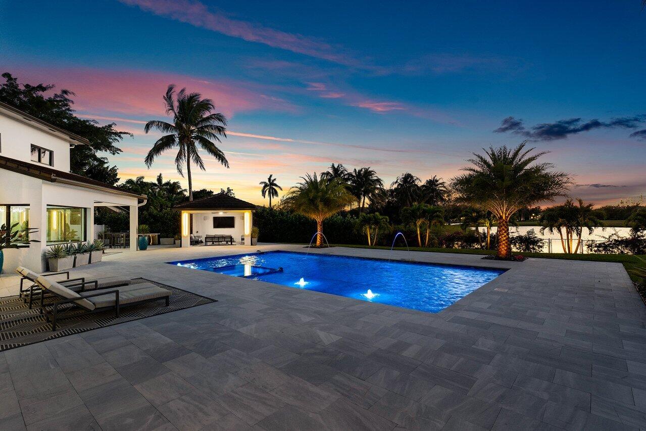 8387 Sawpine Road Delray Beach, FL 33446 - Photo 50 of 57 a swimming pool with outdoor seating and yard
