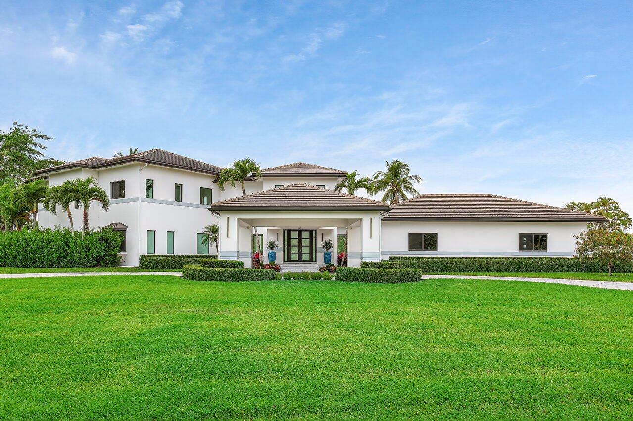 8387 Sawpine Road Delray Beach, FL 33446 - Photo 5 of 57 a view of a house with a big yard and large trees