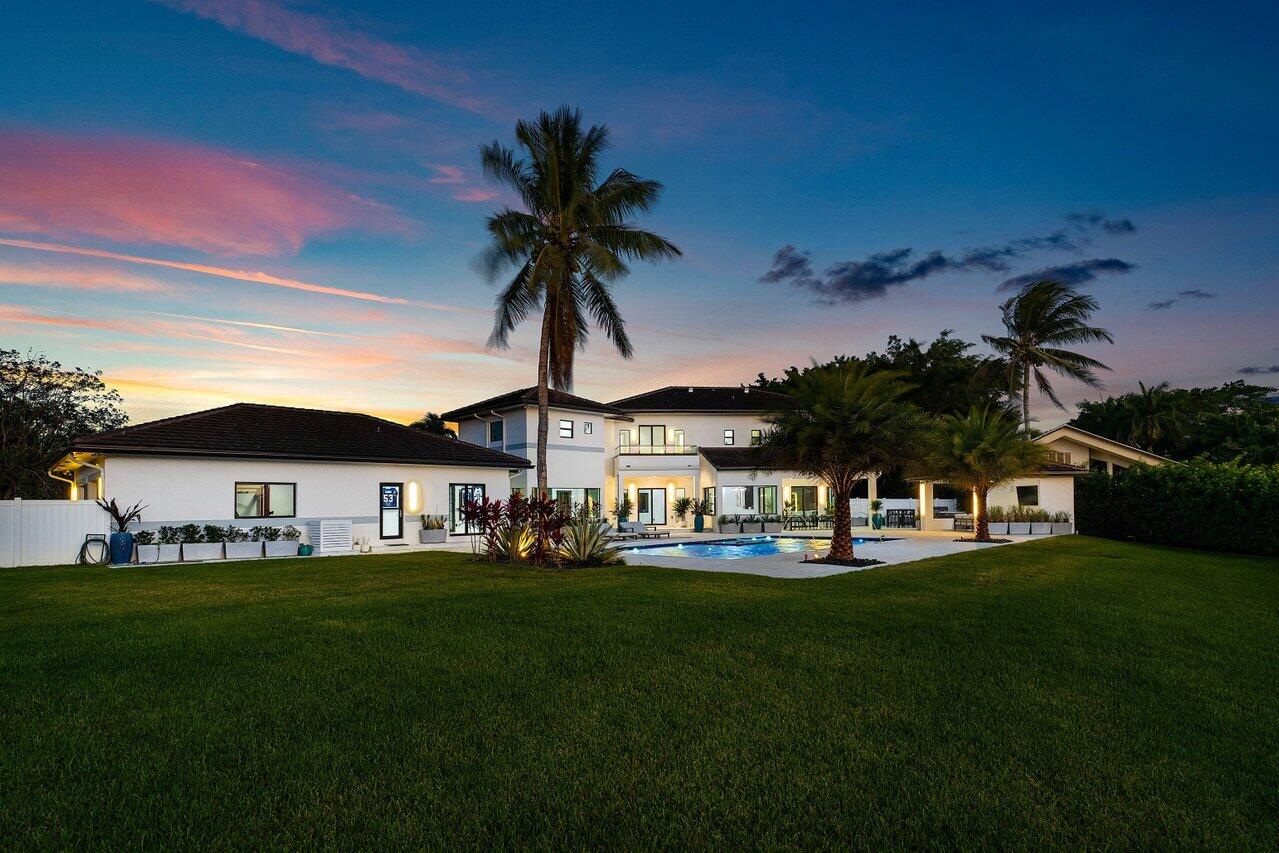 8387 Sawpine Road Delray Beach, FL 33446 - Photo 53 of 57 a front view of a house with garden and trees