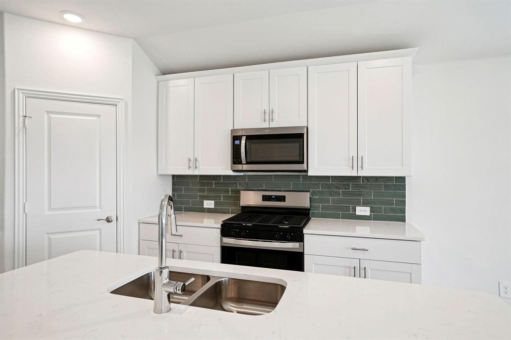827 Sunflower Road Lavon, TX 75166 - Photo 3 of 23 a kitchen with granite countertop white cabinets and stainless steel appliances
