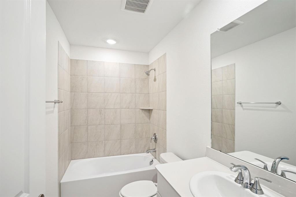 827 Sunflower Road Lavon, TX 75166 - Photo 9 of 23 a bathroom with a bathtub shower sink vanity and toilet