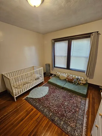 a living room with a couch wooden floor and a table