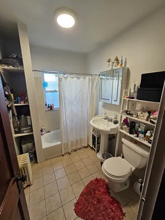 a bathroom with a toilet a sink and a shower