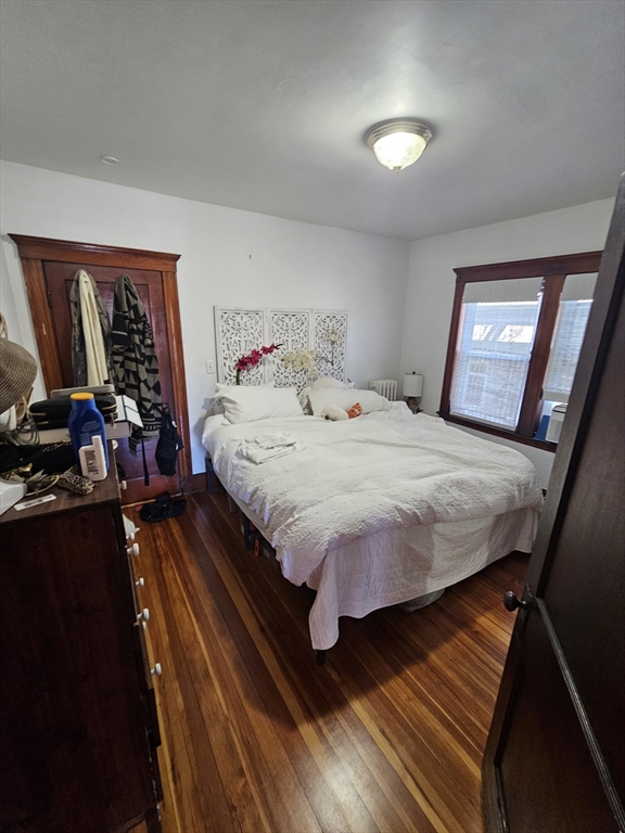 13 Roberts Road Cambridge, MA 02138 - Photo 20 of 23 a bedroom with a bed and wooden floor