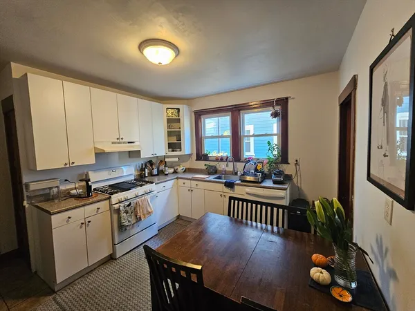 a kitchen with furniture a counter top space a sink stainless steel appliances and cabinets