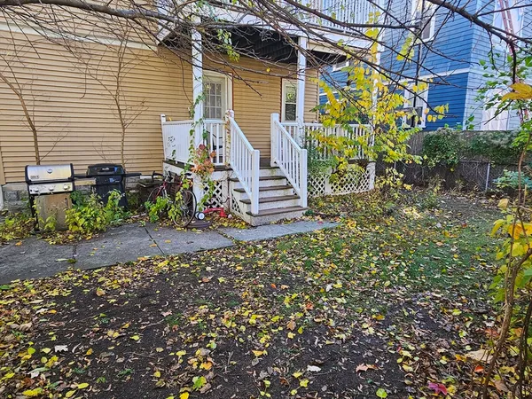a view of a house with a yard and a garden