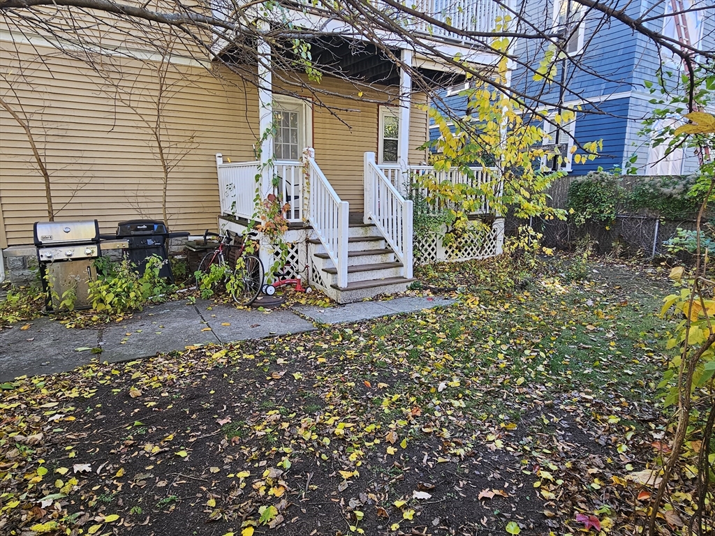 13 Roberts Road Cambridge, MA 02138 - Photo 5 of 23 a view of a house with a yard and a garden