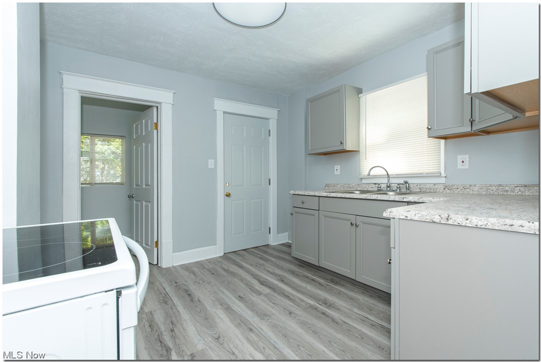 815 Thayer Street Akron, OH 44310 - Photo 13 of 32 Kitchen with sink, gray cabinets, and range