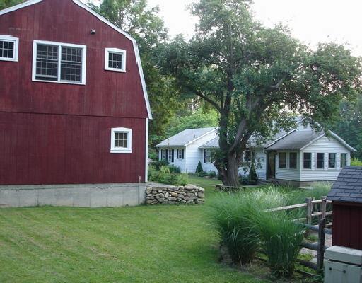 8 Keeler Road Bridgewater, CT 06752 - Photo 1 of 1 a front view of a house with a garden