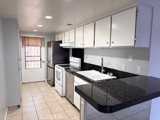 a kitchen with a sink appliances and cabinets