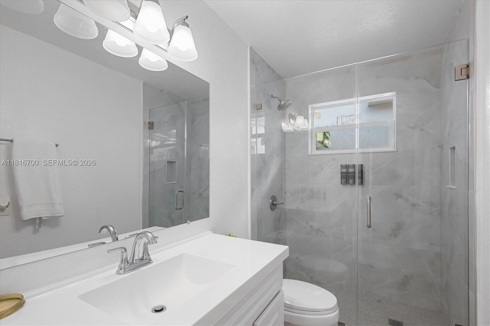 5726 Southwest 20th Street Miami, FL 33155 - Photo 19 of 27 a bathroom with a sink a toilet and shower