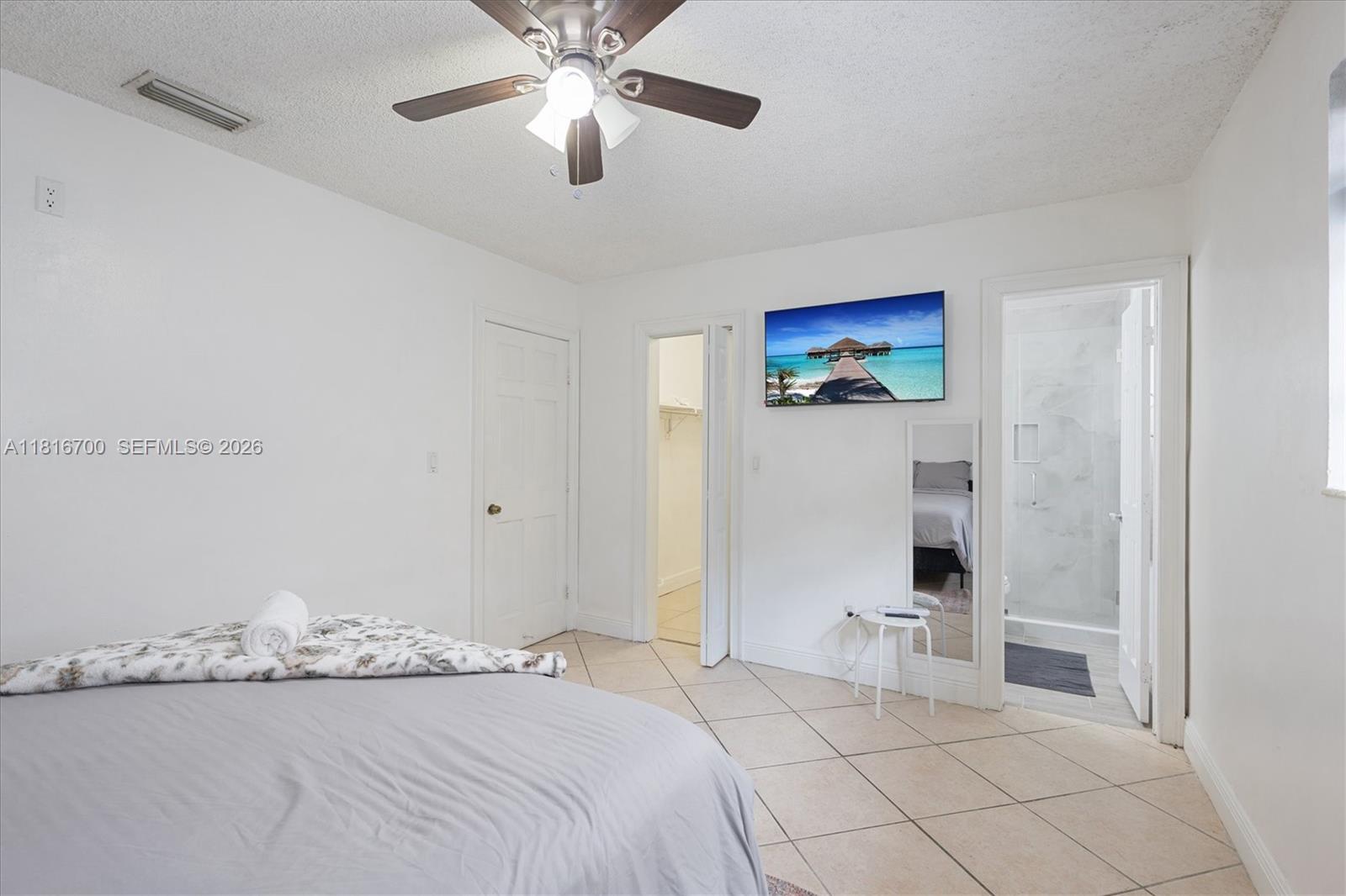 5726 Southwest 20th Street Miami, FL 33155 - Photo 21 of 27 a bedroom with a bed and a painting on the wall