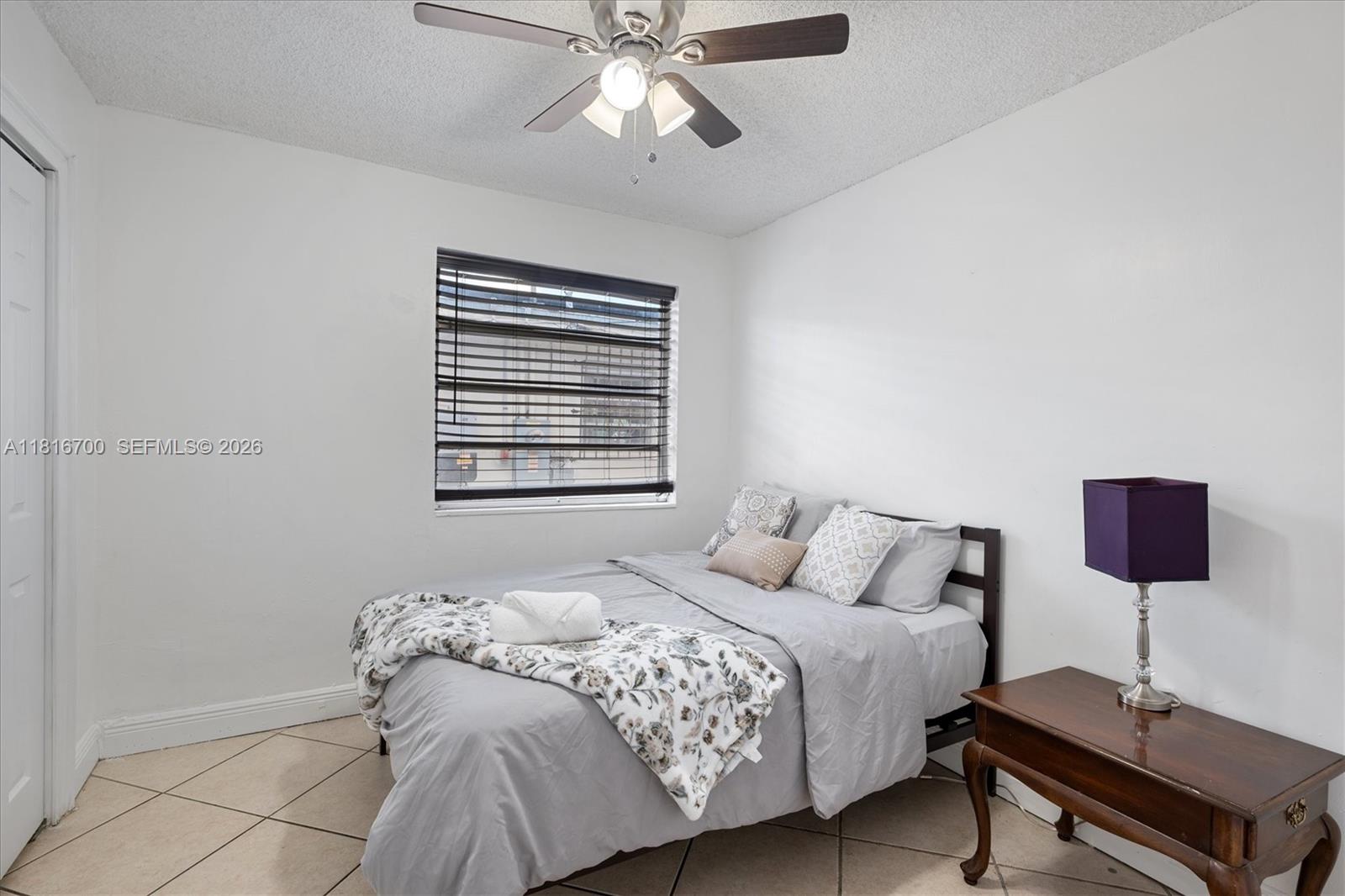 5726 Southwest 20th Street Miami, FL 33155 - Photo 6 of 27 a bedroom with a bed and a window