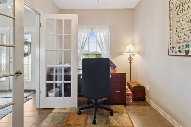 a view of a workspace with furniture and a window