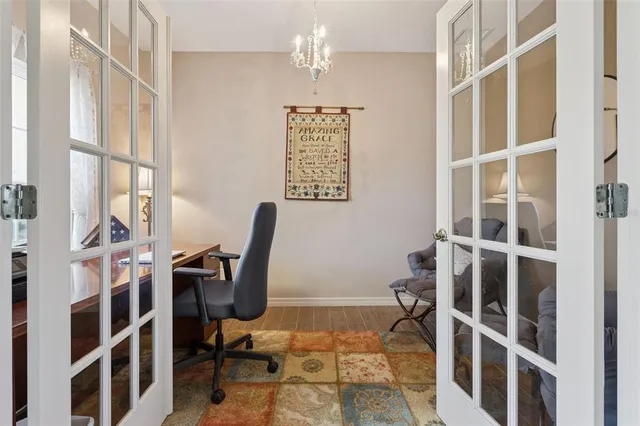 a view of a workspace with furniture and a window