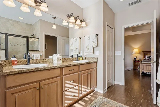 a bathroom with a sink a vanity a mirror and a shower