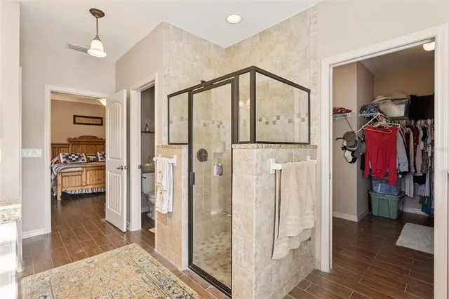 a view of hallway with furniture and wooden floor