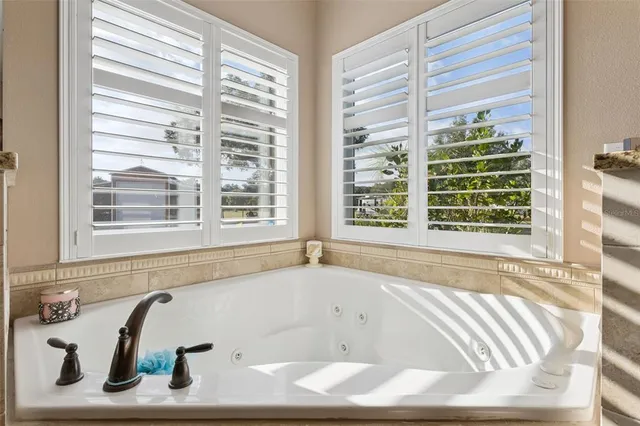 a bath tub sitting in front of a window