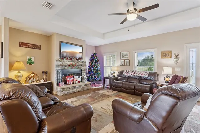 a living room with furniture a fireplace and a window