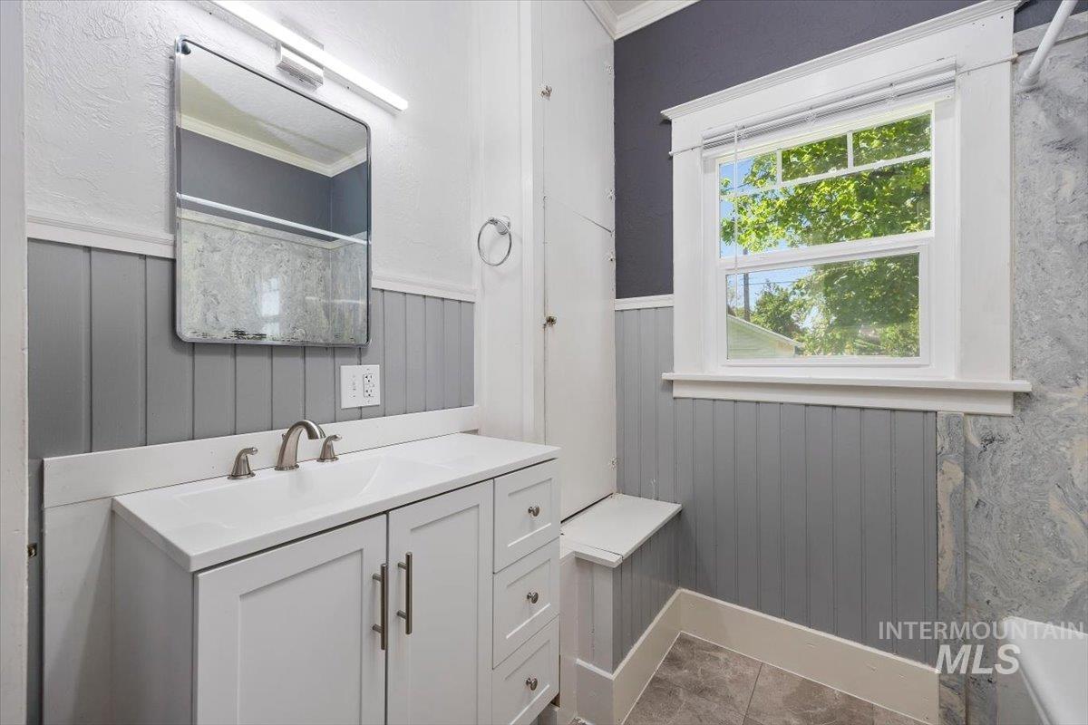 813 7th Street Rupert, ID 83350 - Photo 28 of 48 Bathroom featuring a white vanity with integrated sink, brushed nickel faucet, and a rectangular mirror with overhead lighting