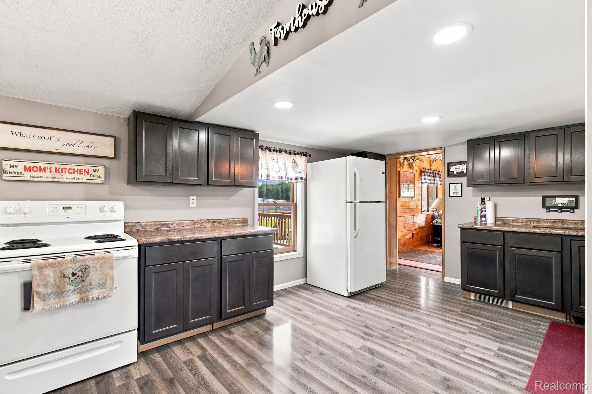 4201 Galbraith Line Road Croswell, MI 48422 - Photo 15 of 39 Kitchen featuring wood-finish flooring, dark cabinetry, and recessed lighting