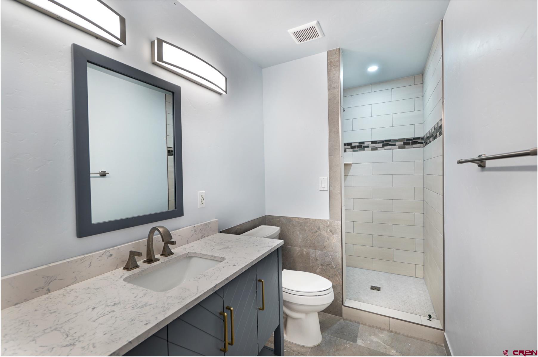 120 Sortais Road Durango, CO 81301 - Photo 12 of 21 a bathroom with a granite countertop sink toilet and shower