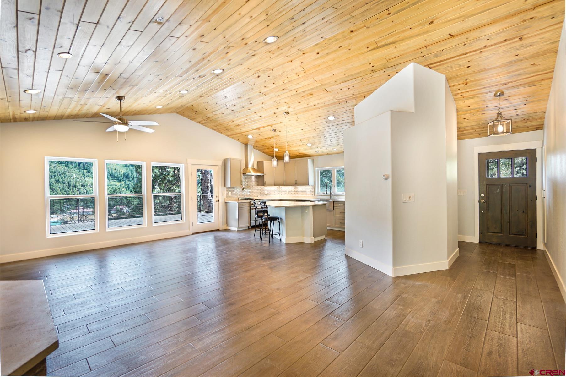 120 Sortais Road Durango, CO 81301 - Photo 2 of 21 a view of an empty room with wooden floor and a window